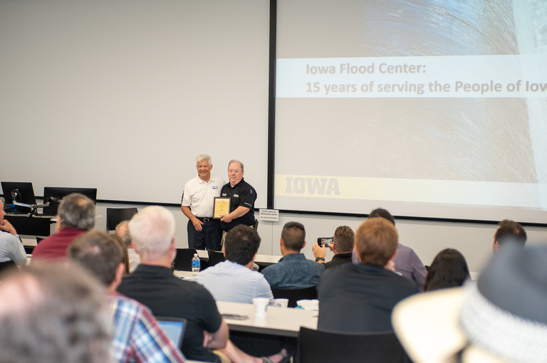 Witold Krajewski receives recognition from Dave Wilson, Johnson County Emergency Manager