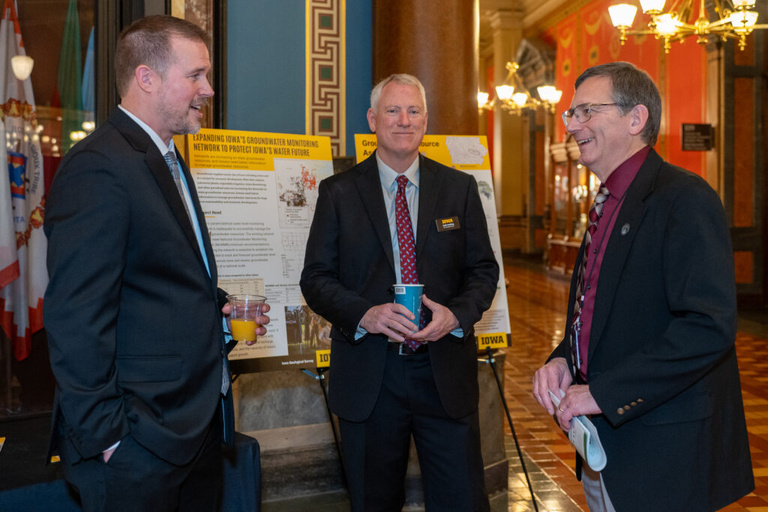 IGS staff converses with visitors at the Legislative Breakfast event at the Iowa State Capital Rotunda