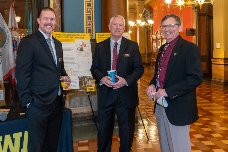 IGS staff talks to a legislator at the Legislative Breakfast event at the Iowa State Capital Rotunda