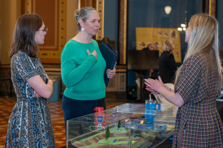 IFC staff explains the watershed model used for outreach at the Legislative Breakfast event at the Iowa State Capital Rotunda