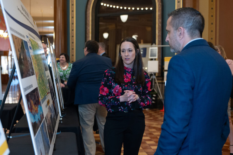 IFC staff converses with visitors at the Legislative Breakfast event at the Iowa State Capital Rotunda