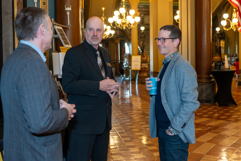 IFC staff and partners chat at the Legislative Breakfast event at the Iowa State Capital Rotunda