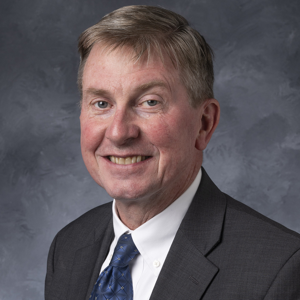 Headshot of Larry Weber in a dark suit and tie