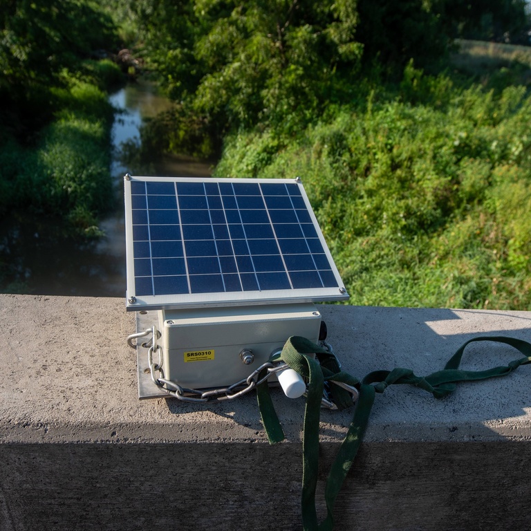 An IFC stream sensor is laid on a concrete bridge, ready for installation