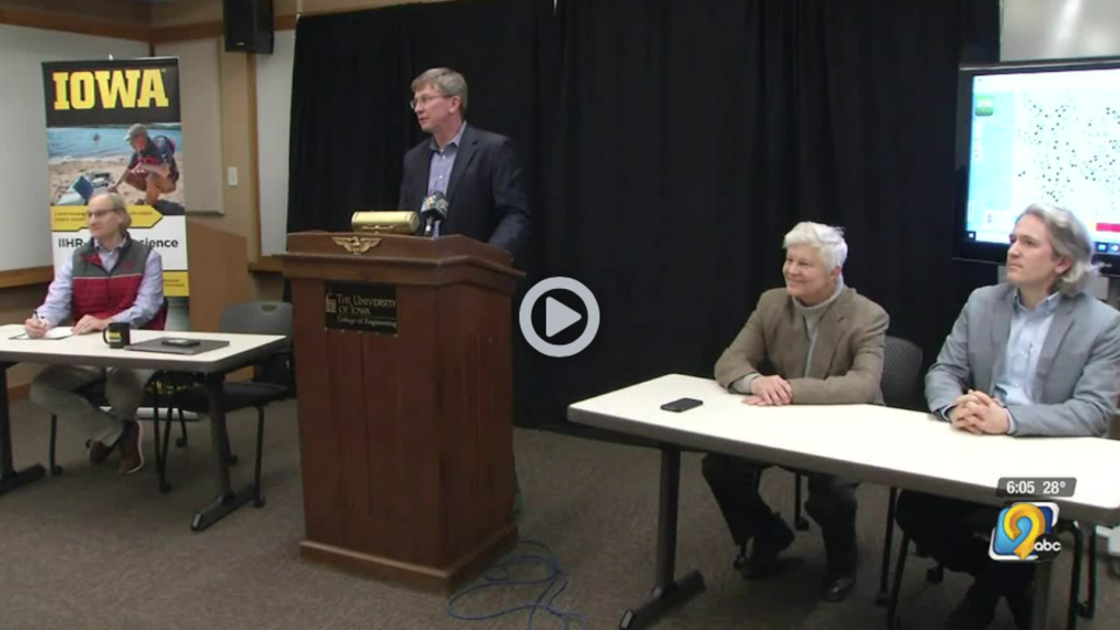 A video still showing Larry Weber speaking at a press conference